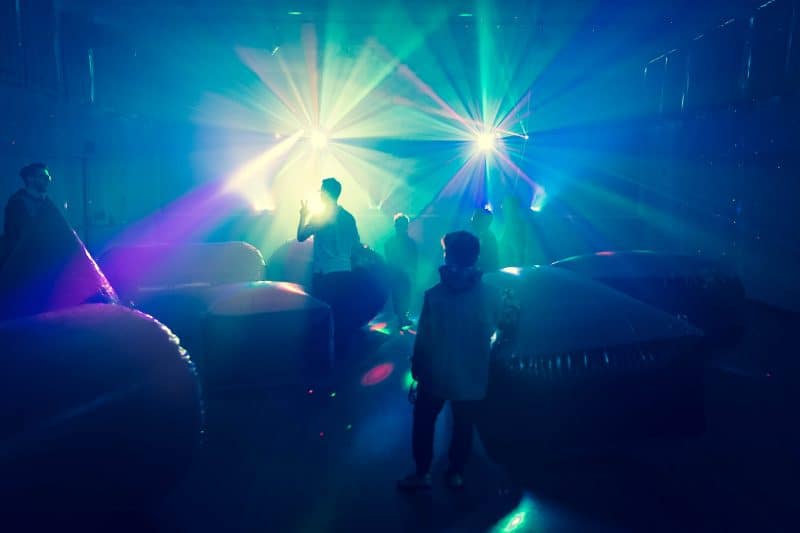 Players silhouetted against arena lasers