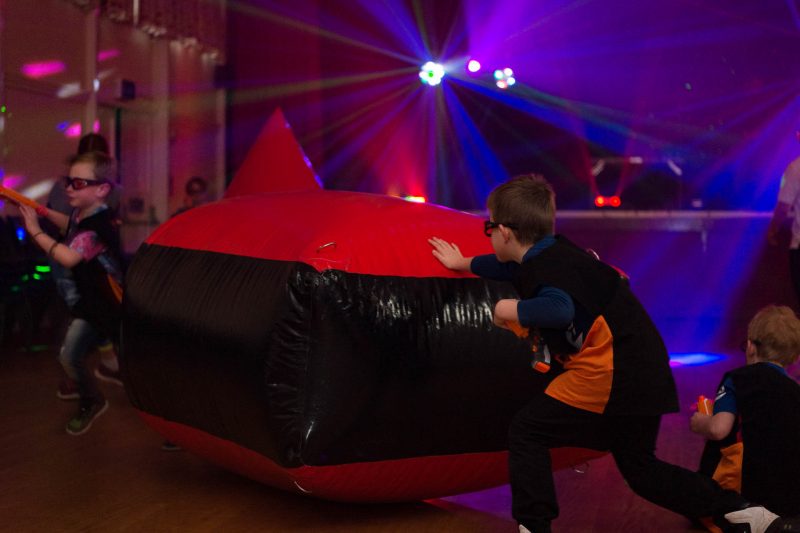 Boy moving an inflatable barricade mid-game