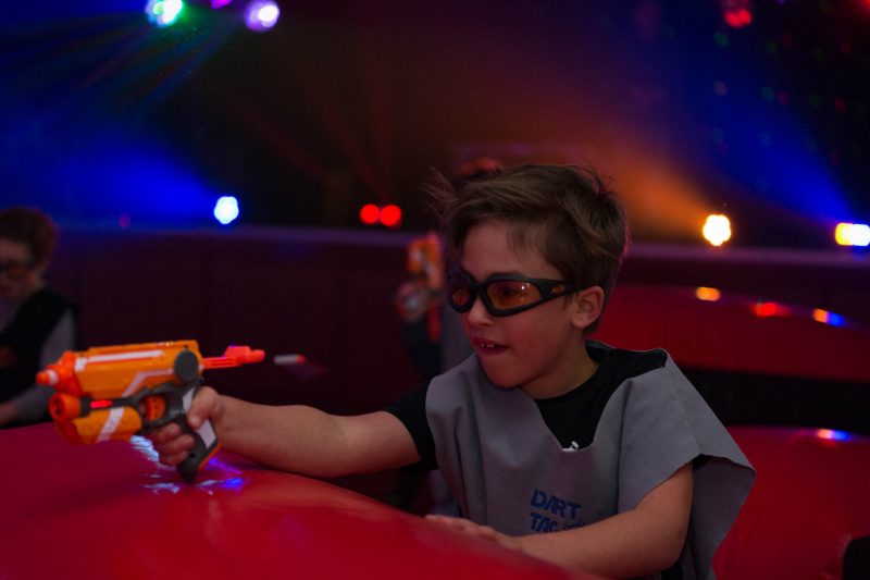 Boy in safety goggles lining up a shot